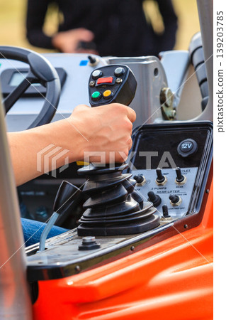 Man operating big industrial agricultural machine Man operating big industrial agricultural machine 139203785