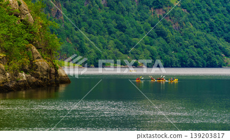 fjord in Norway and people kayaking fjord in Norway and people kayaking 139203817