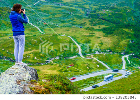 Tourist with camera and in Norway mountains 139203845