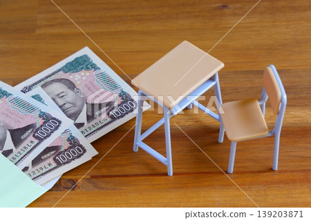 Rising education costs - The image of rising education costs that comes to mind when you think of school desks and chairs and money. 139203871