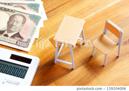 Soaring Education Costs - The image of school desks, chairs, and calculators evokes the image of ever-increasing education costs that are putting a strain on household budgets. 139204006