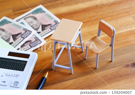 Soaring Education Costs - The image of school desks, chairs, and calculators evokes the image of ever-increasing education costs that are putting a strain on household budgets. Soaring Education Costs - The image of school desks, chairs, and calculators evokes the image of ever-increasing education costs that are putting a strain on household budgets. 139204007