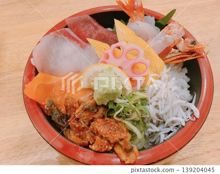 A luxurious seafood bowl topped with fresh ingredients. A luxurious seafood bowl topped with fresh ingredients. 139204045