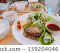 A hearty hamburger steak set meal with a side salad. 139204046