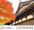 Traditional Japanese temple roofs and vibrant autumn leaves 139204048