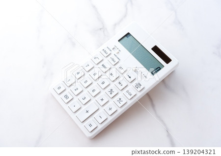 Calculator - A white calculator on a table Calculator - A white calculator on a table 139204321