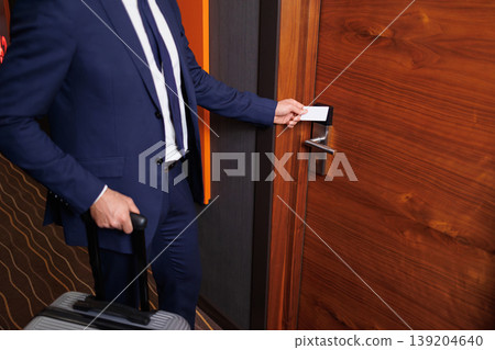 Close Up Of Business Traveler Opening Hotel Room Door With Electronic Key Card Close Up Of Business Traveler Opening Hotel Room Door With Electronic Key Card 139204640