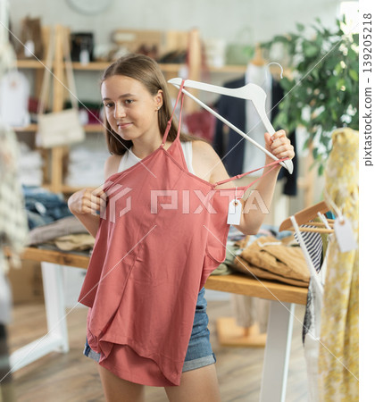 teenager chooses tops for the summer 139205218