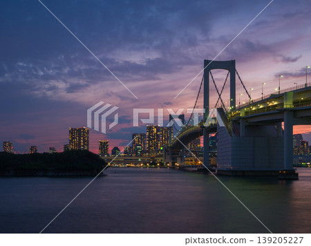 A night view of the city and Rainbow Bridge as lights begin to come on against the sky just after sunset (Odaiba, Minato Ward, Tokyo) A night view of the city and Rainbow Bridge as lights begin to come on against the sky just after sunset (Odaiba, Minato Ward, Tokyo) 139205227