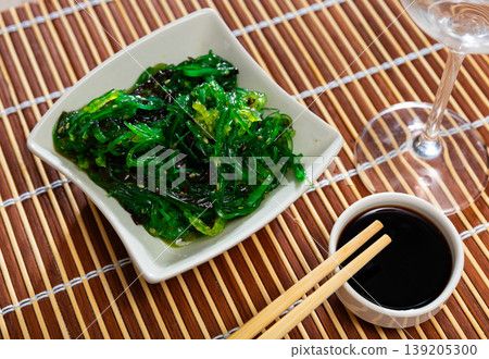 Goma Wakame salad served in a plate with soy sauce Goma Wakame salad served in a plate with soy sauce 139205300