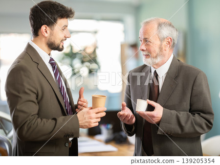 Two men colleagues chat and laugh during coffee break 139205354