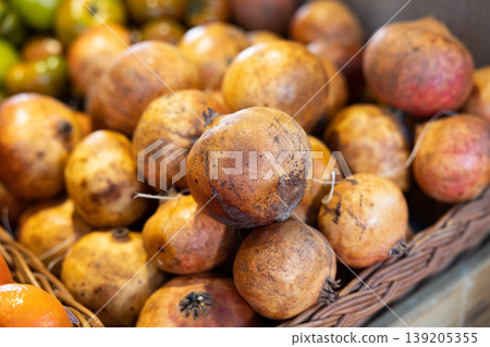 Fresh ripe pomegranates on the counter market. Grenades on counter for sale 139205355