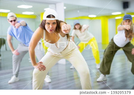 Young girl in cap dancing hip hop 139205379