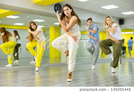 Young girl dancing modern dance in studio Young girl dancing modern dance in studio 139205448