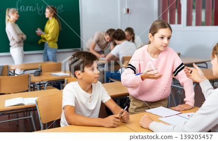 Schoolchilds working in groups at lesson 139205457