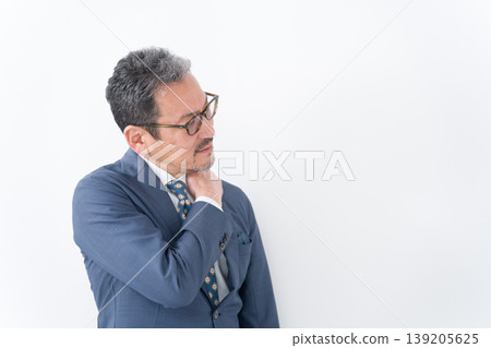 Businessman with stiff shoulders Businessman with stiff shoulders 139205625