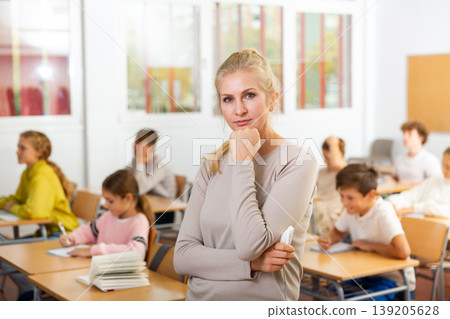 Portrait of thoughtful teacher in classroom 139205628