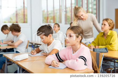 Portrait of schoolgirl at lesson in school Portrait of schoolgirl at lesson in school 139205716