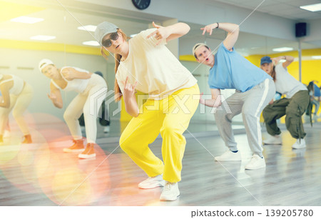 Expressive cool young dancers rehearsing their new dance during training together in studio 139205780