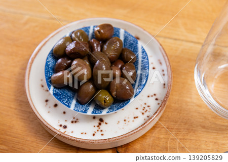 Green olives with pits served in bowl Green olives with pits served in bowl 139205829