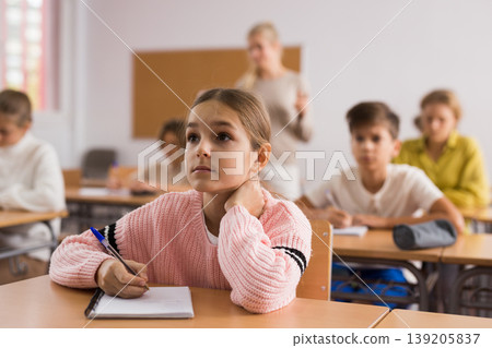 Teenage students are sitting at their desks Teenage students are sitting at their desks 139205837