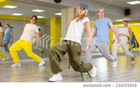 Teen girl in cap dancing modern dances Teen girl in cap dancing modern dances 139205838