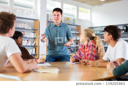 Group of schoolchildren in the school library, discussing something Group of schoolchildren in the school library, discussing something 139205863
