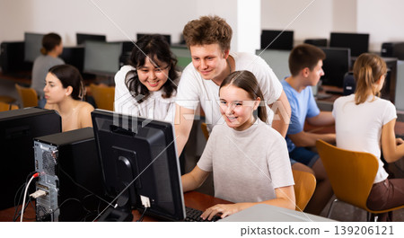 Portrait of multinational young students group emotionally reacting while studying at pc in computer class Portrait of multinational young students group emotionally reacting while studying at pc in computer class 139206121