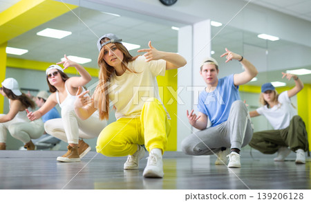 Teen girl in cap dances hip hop dances 139206128
