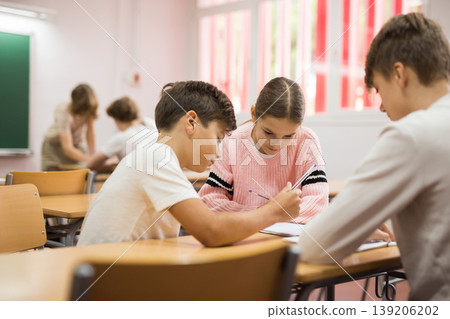 Pupils performing group tasks in classroom Pupils performing group tasks in classroom 139206202