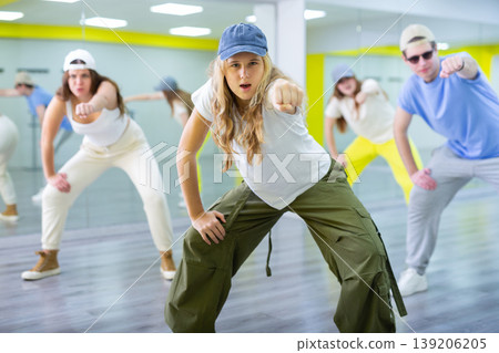Teenages hip hop dancers doing dance workout during group class Teenages hip hop dancers doing dance workout during group class 139206205