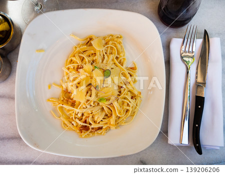 Spaghetti tagliatelle carbonara with parmesan cheese closeup Spaghetti tagliatelle carbonara with parmesan cheese closeup 139206206