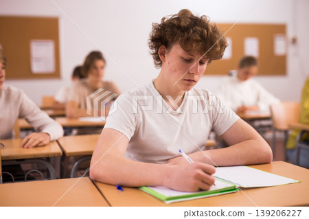 Teenager boy in class room in school Teenager boy in class room in school 139206227