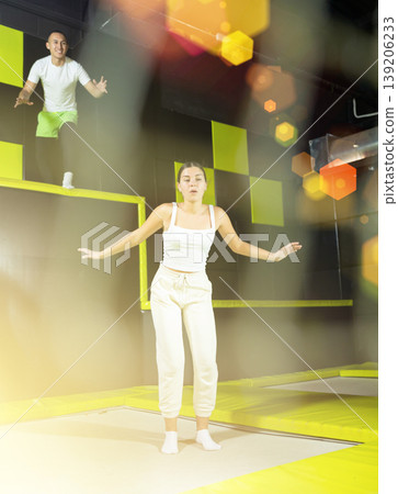 Woman sportswoman fitness jumping on club trampoline Woman sportswoman fitness jumping on club trampoline 139206233