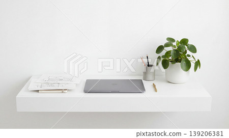 Minimalist floating shelf with a laptop notebook plant writing tools the composition is minimalist and organized against a plain white wall home office wall mounted green plant organization Minimalist floating shelf with a laptop notebook plant writing tools the composition is minimalist and organized against a plain white wall home office wall mounted green plant organization 139206381