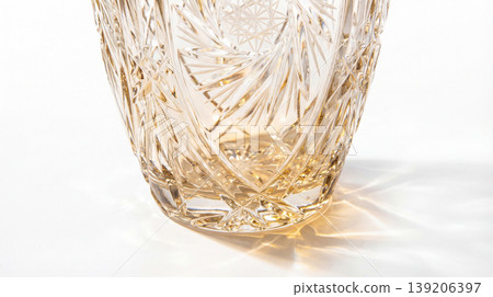 Close-up of an intricately patterned amber glass vase with intricate textured decoration interior ornament translucent transparent material container collectible household photograph Close-up of an intricately patterned amber glass vase with intricate textured decoration interior ornament translucent transparent material container collectible household photograph 139206397