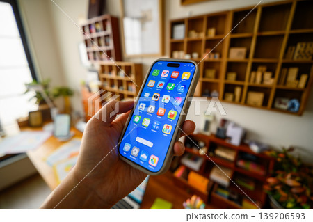 Holding a smartphone in hand 139206593