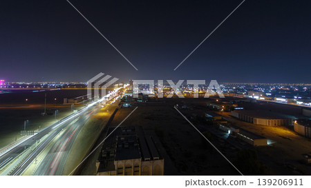 Traffic on a big road junction in Ajman aerial view from rooftop at night timelapse. Traffic on a big road junction in Ajman aerial view from rooftop at night timelapse. 139206911
