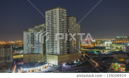 Cityscape with towers in Ajman from rooftop day to night timelapse. United Arab Emirates. Cityscape with towers in Ajman from rooftop day to night timelapse. United Arab Emirates. 139206914