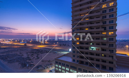 Cityscape with towers in Ajman from rooftop day to night timelapse. United Arab Emirates. Cityscape with towers in Ajman from rooftop day to night timelapse. United Arab Emirates. 139206916
