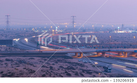 Highway roads with traffic day to night timelapse in a big city from Ajman to Dubai before sunset. Transportation concept. Highway roads with traffic day to night timelapse in a big city from Ajman to Dubai before sunset. Transportation concept. 139206919