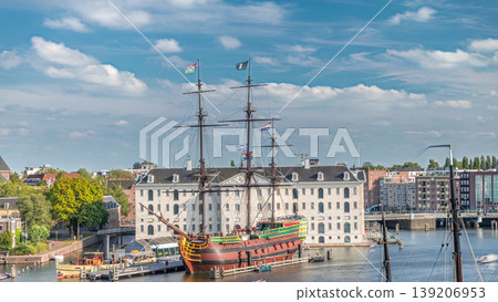 Aerial timelapse of the National Maritime Museum with the sailboat replica Amsterdam docked nearby. Amsterdam, Netherlands 139206953