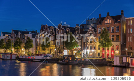Panoramic timelapse hyperlapse of the illuminated famous Dancing Houses along the Amstel River day to night transition. Amsterdam, Netherlands Panoramic timelapse hyperlapse of the illuminated famous Dancing Houses along the Amstel River day to night transition. Amsterdam, Netherlands 139206956