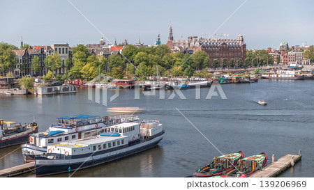 Amsterdam skyline panorama with boats at the pier in Oosterdok harbor aerial timelapse. Amsterdam, The Netherlands 139206969