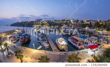 Aerial view of yacht harbor and red house roofs in Old town day to night timelapse Antalya, Turkey. 139206990