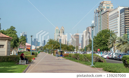 Corniche boulevard beach park along the coastline in Abu Dhabi timelapse with skyscrapers on background. Corniche boulevard beach park along the coastline in Abu Dhabi timelapse with skyscrapers on background. 139207000