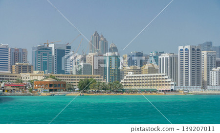 Modern buildings in Abu Dhabi skyline timelapse with mall and beach. Modern buildings in Abu Dhabi skyline timelapse with mall and beach. 139207011