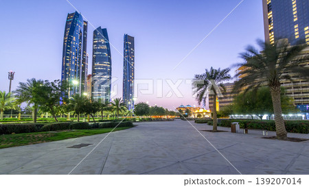 Skyscrapers of Abu Dhabi with Etihad Towers buildings day to night timelapse. 139207014