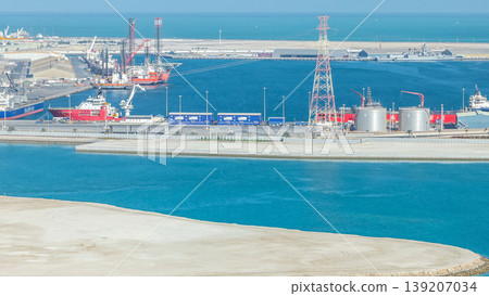 Big cargo ship at industrial port timelapse aerial view from above at evening in Abu Dhabi Big cargo ship at industrial port timelapse aerial view from above at evening in Abu Dhabi 139207034