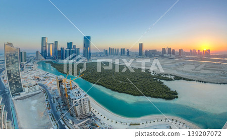 Buildings on Al Reem island in Abu Dhabi at sunset timelapse from above. Buildings on Al Reem island in Abu Dhabi at sunset timelapse from above. 139207072